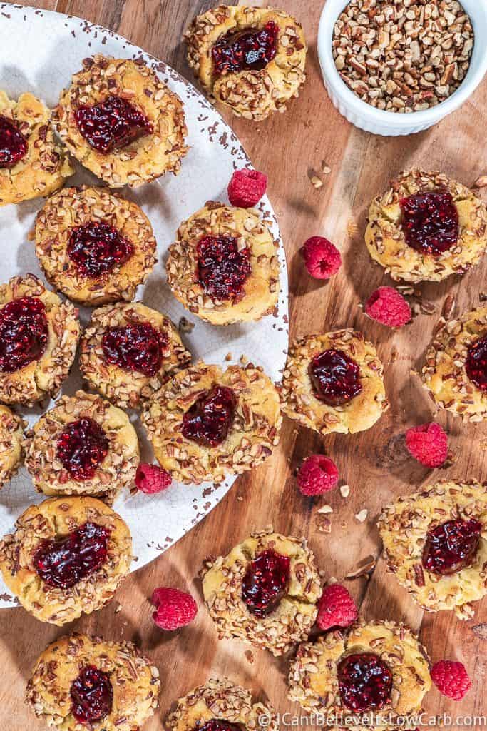 plate and table full of raspberry thumbprint cookies