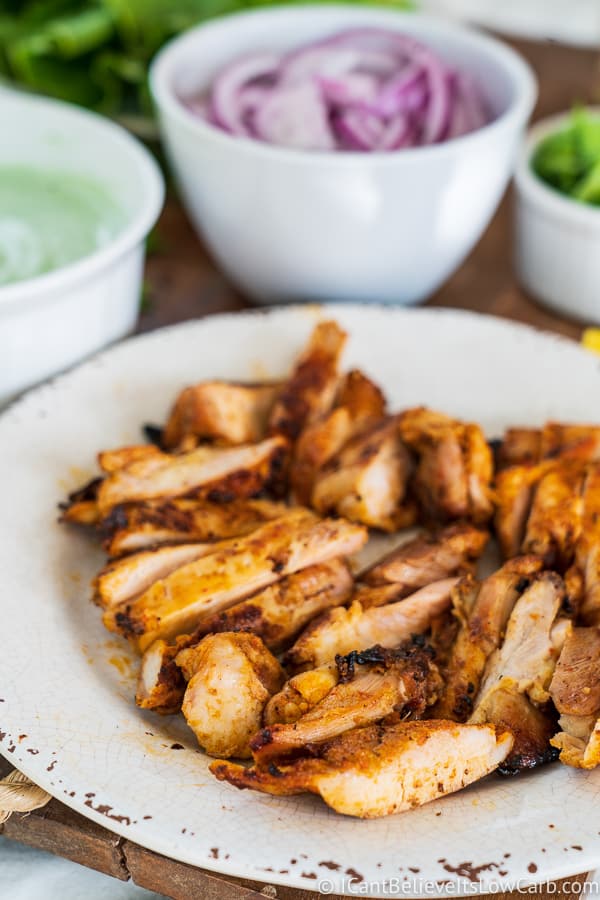 cut chicken on plate for Tandoori Chicken recipe