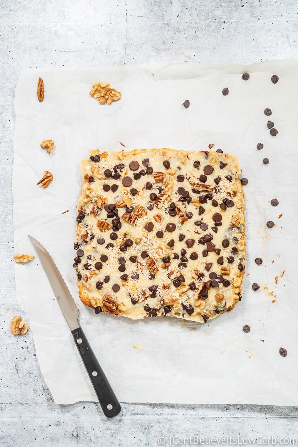 cutting Magic Cookie Bars out of oven