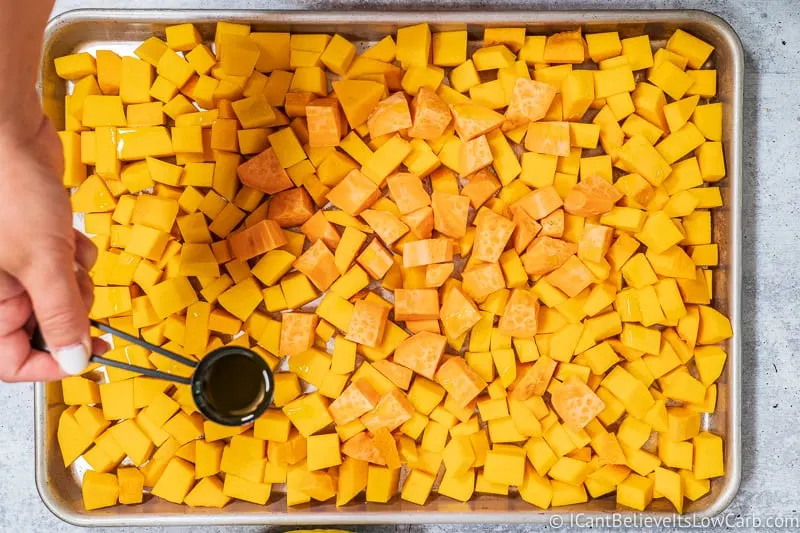 pouring oil on Butternut Squash