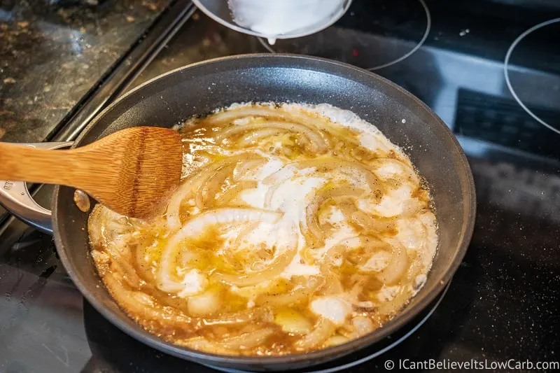 adding cream to onions and butter for Green Bean Casserole