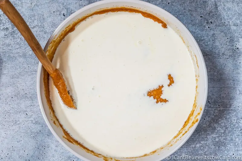 adding cream to Keto Pumpkin Pie Recipe
