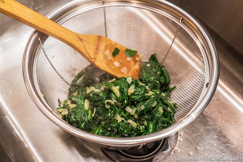 Spinach in a colander for creamed spinach