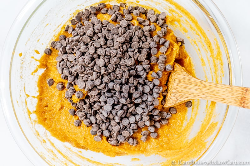 adding chocolate chips to Low Carb Pumpkin Chocolate Chip Muffins