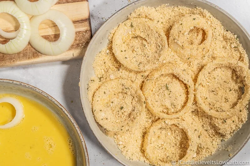 coating Keto Onion Rings in almond flour breadcrumbs