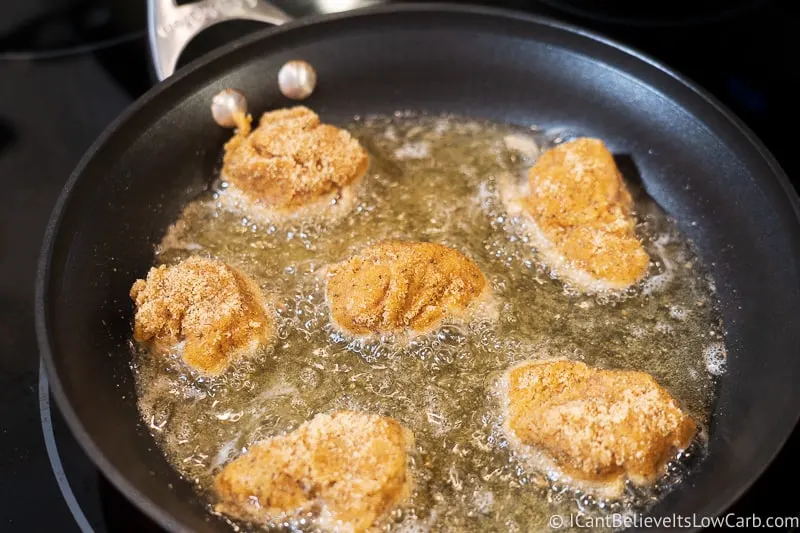 frying Keto Chicken Nuggets in a pan