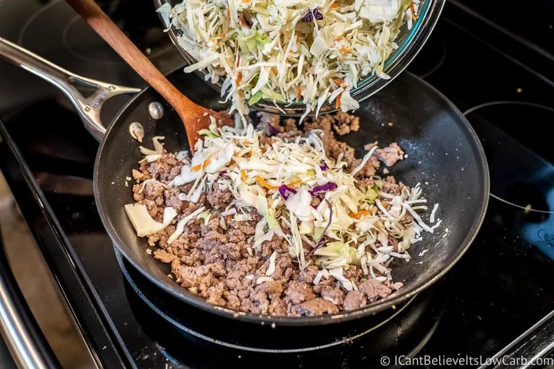 adding coleslaw to Keto Egg Roll in a Bowl