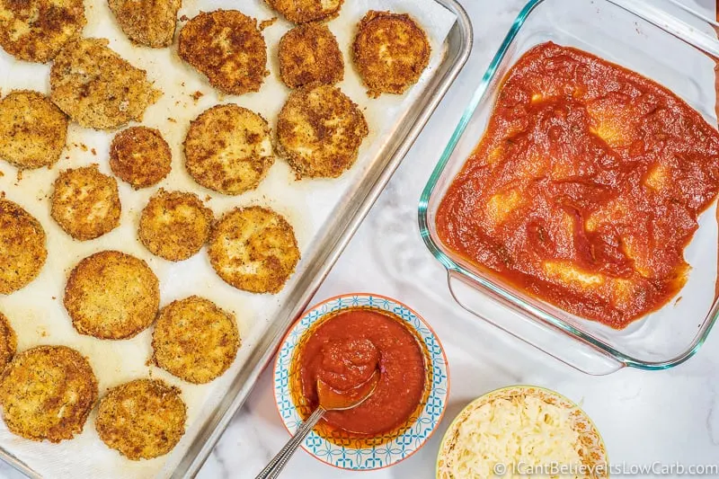 tomato sauce in baking dish for low carb Keto Eggplant Parmesan