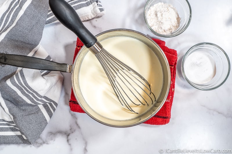 Keto Ice Cream custard in a pan with whisk
