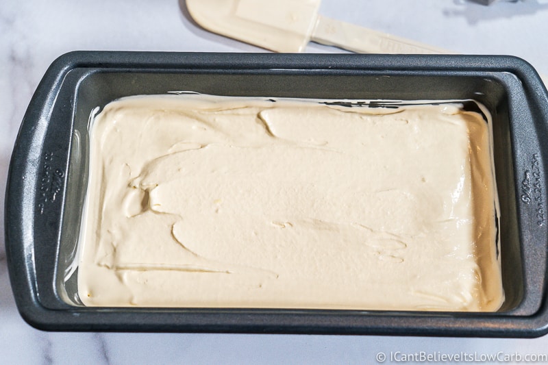 spreading Low Carb Vanilla Ice Cream in loaf pan