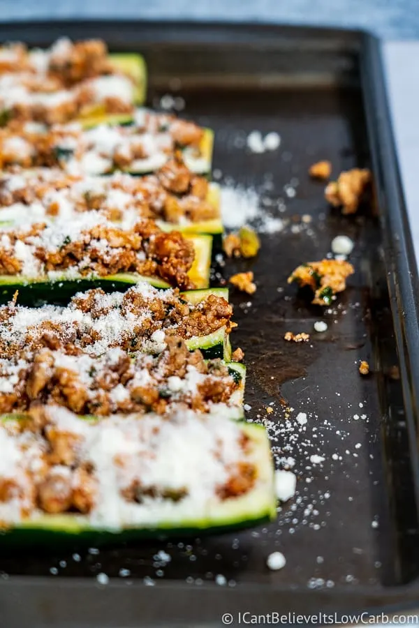adding parmesan cheese to Low Carb Zucchini Boats