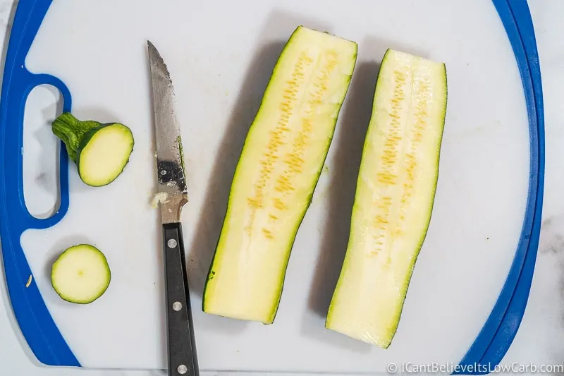 slicing zucchini on a cutting board
