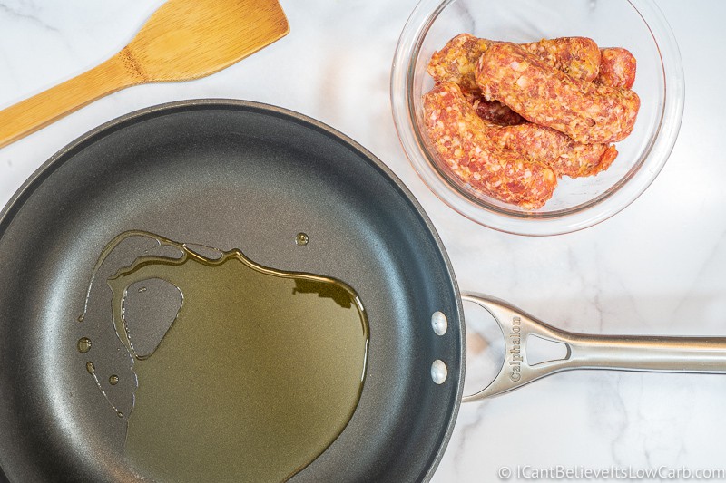 olive oil in pan with sausage