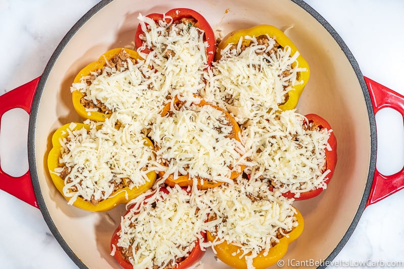 stuffed bell peppers in pan with mozzarella cheese ready to cook