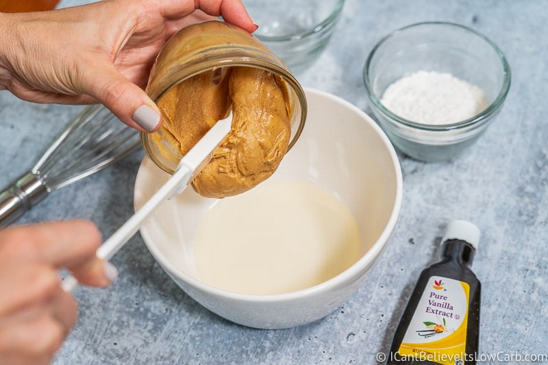 pouring peanut butter into coconut oil