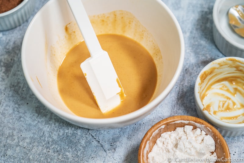 peanut butter and coconut oil mixed in a white bowl