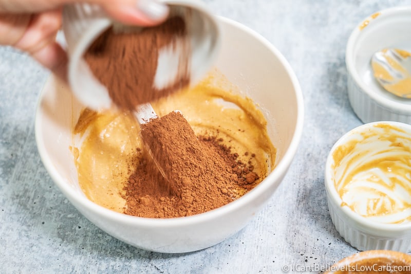adding cacao powder to Peanut Butter Fat Bomb mixture