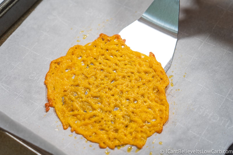 scraping up Cheddar Cheese Taco Shells with spatula
