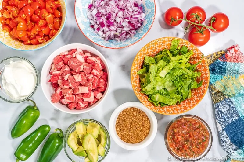 Keto Taco Ingredients on table meat lettuce and tomatoes