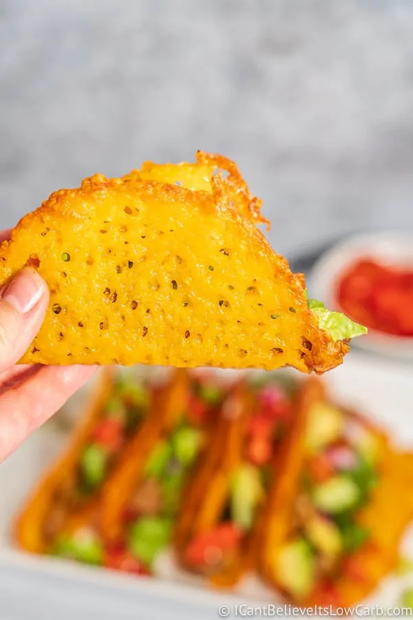 Low Carb cheese Taco shell being held in the air