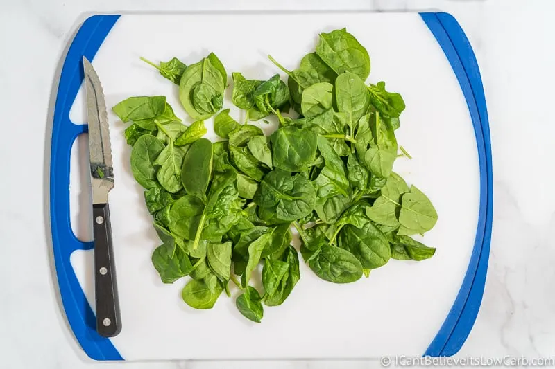 Chopping Spinach on a cutting board