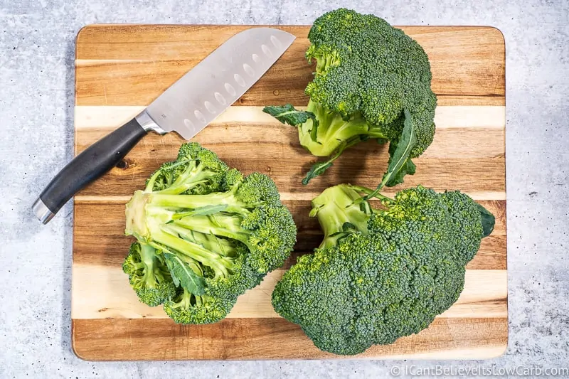 Broccoli Florets and knife on cutting board