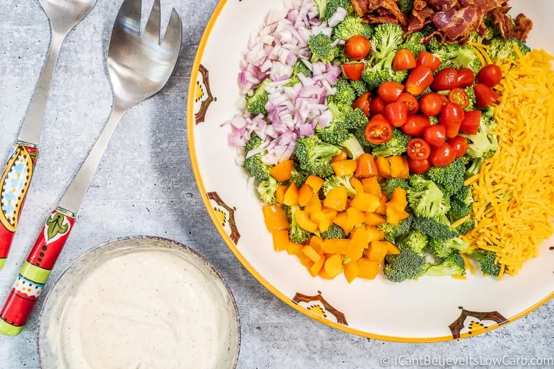 low carb Broccoli Salad ingredients in bowl with dressing on side