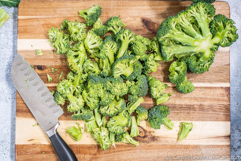 Broccoli florets chopped on a cutting board for salad