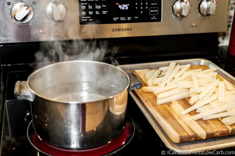 pot of boiling water on stove with cut Jicama Fries