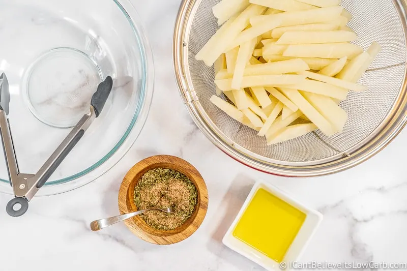 preparing Keto French Fries on table with spices and oil