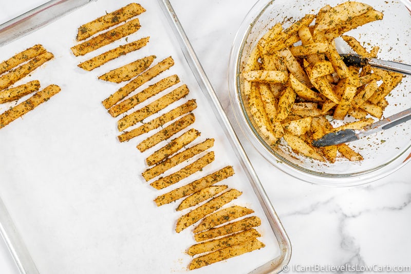 placing uncooked Keto Fries on tray
