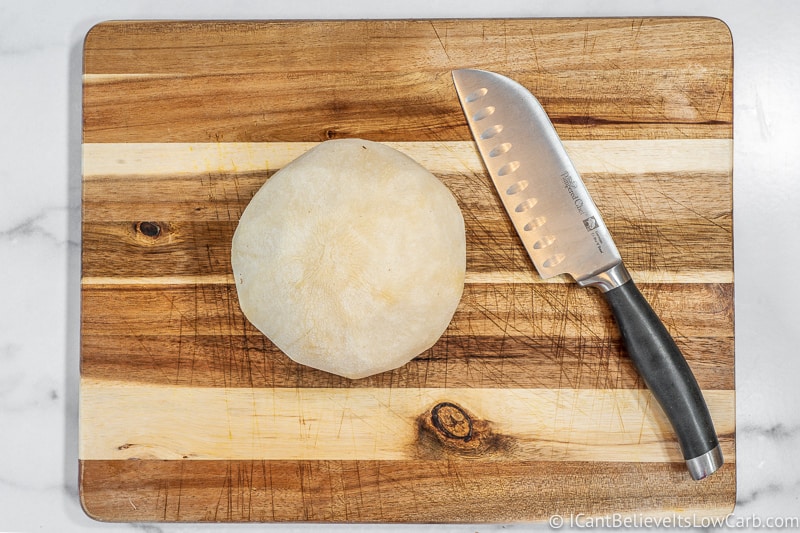 Jicama on cutting board with knife