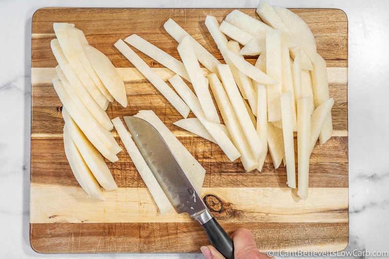 cutting Keto Jicama Fries on cutting board