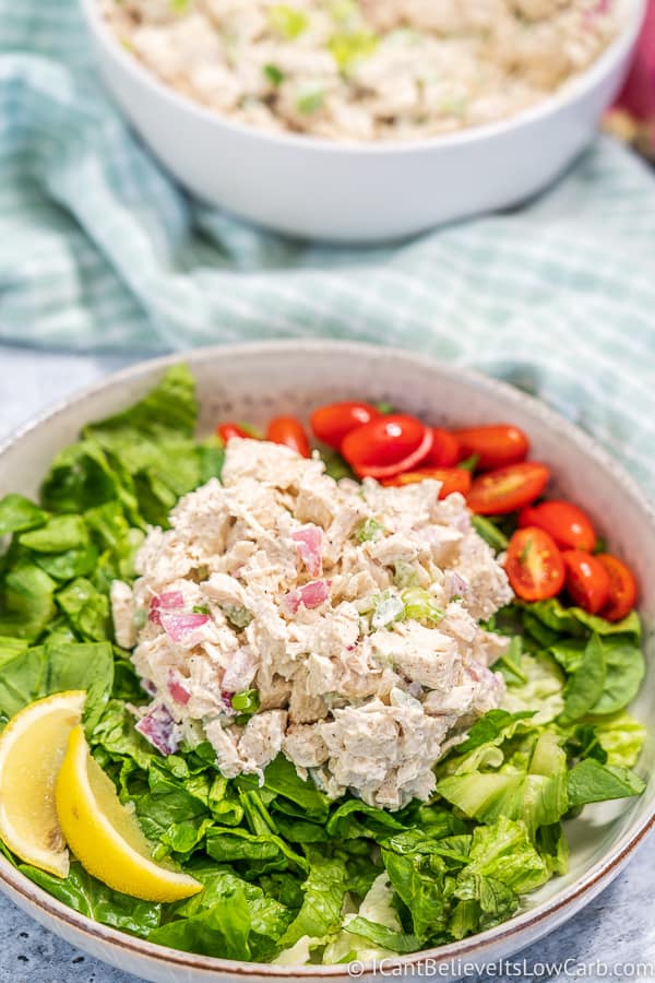 bowl of Keto Chicken Salad with lettuce tomatoes and lemon