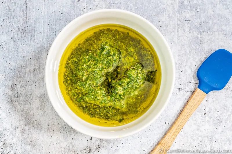 adding olive oil to basil Pesto sauce