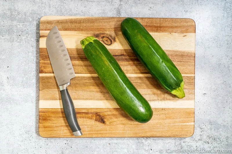 Zucchini on cutting board with knife