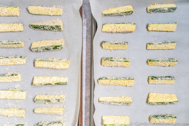 two sheet pans full of Zucchini Fries ready to bake