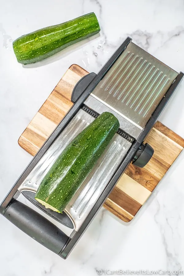 making Zucchini Noodles with mandolin slicer