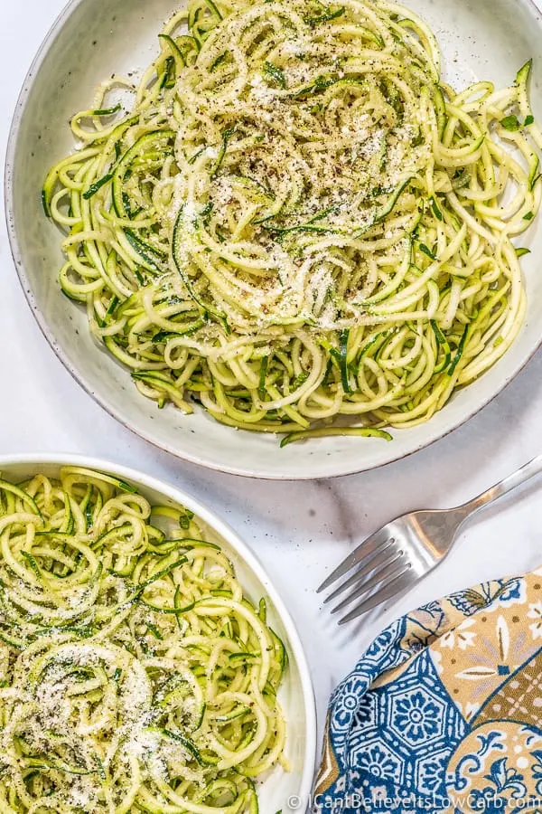 Zucchini Noodles in two bowls with parmesan cheese