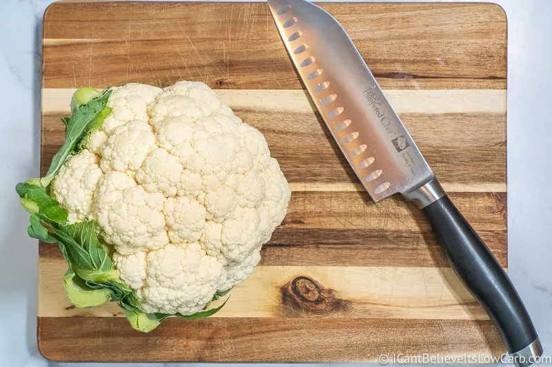 head of Cauliflower on cutting board with knife