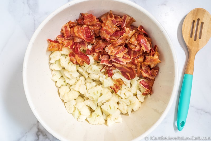 adding bacon to Keto Cauliflower Potato Salad