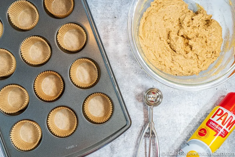 Muffin tin with liners and Keto Banana Muffin mix in bowl
