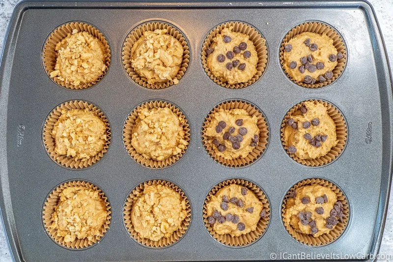 Keto Banana Muffins before baking with walnuts and chocolate chips on top