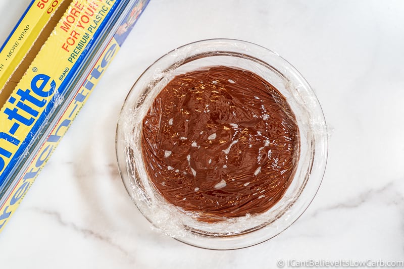 Covering Keto Chocolate Pudding with plastic wrap