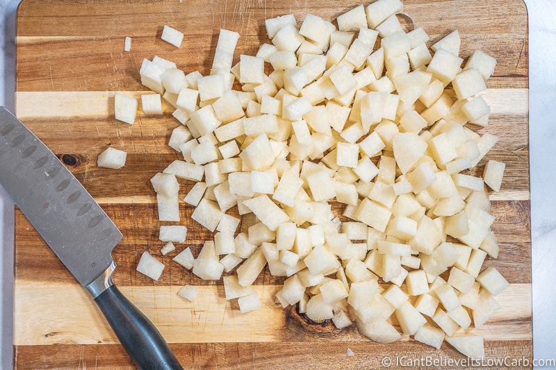 Jicama on a cutting board chopped in cubes