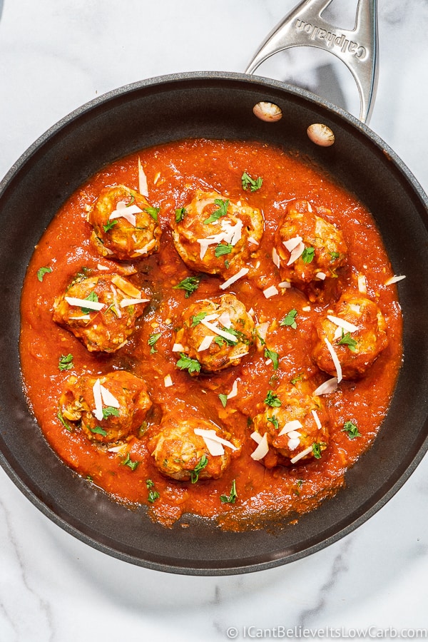 cooking Turkey Zucchini Meatballs in pan with tomato sauce