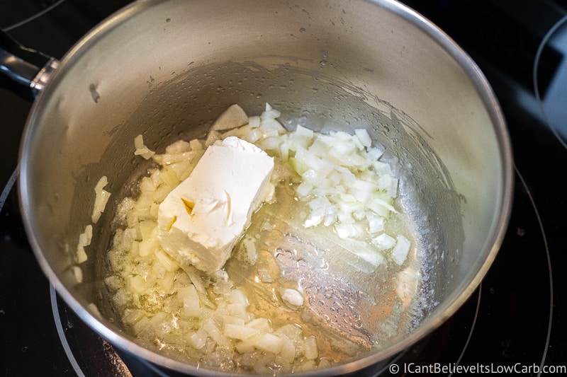 cream cheese melting in pan with onions and butter