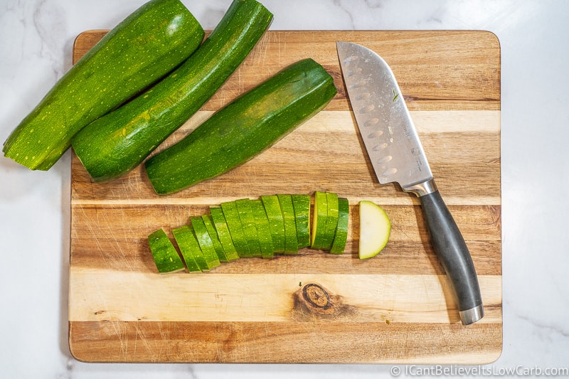 Chopping Zucchini on wooden cutting board
