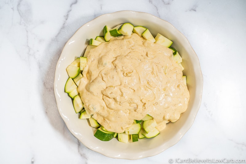 Cheese sauce poured over Zucchini Casserole