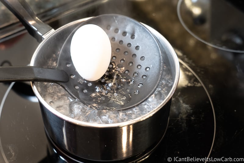 Lowering Eggs into boiling water
